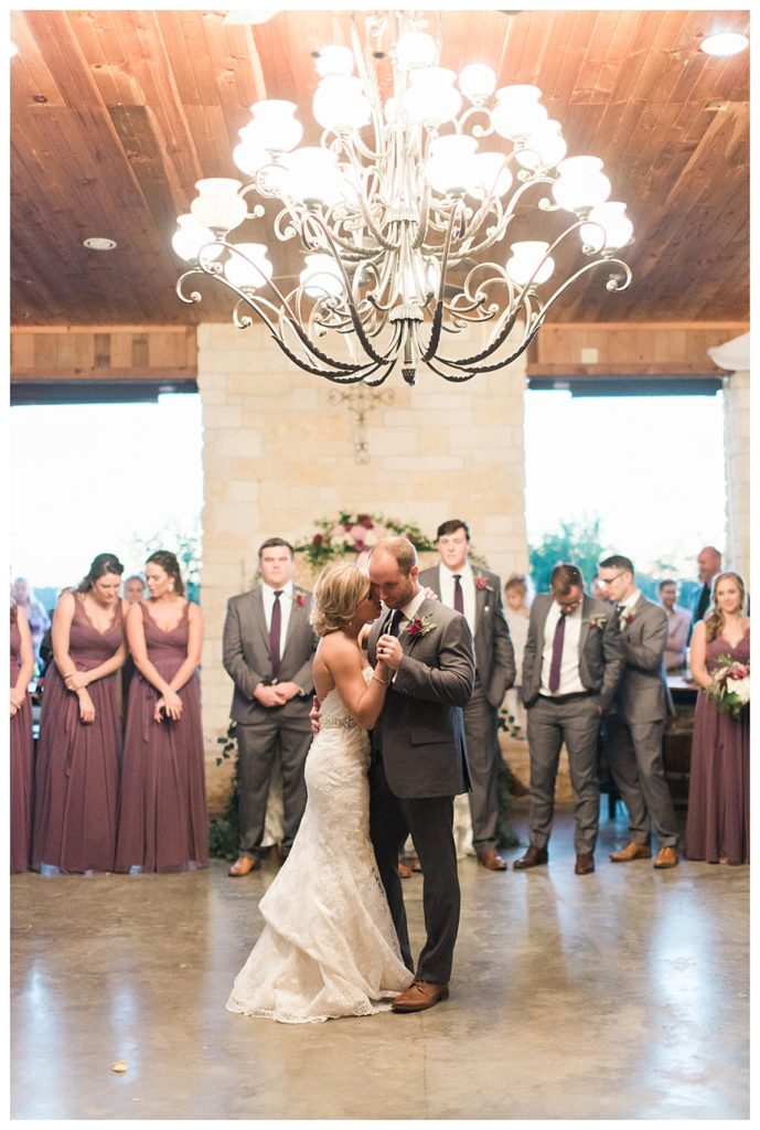 Bride and Groom first dance under the texas iron works chandelier at Emery's Buffalo Creek 