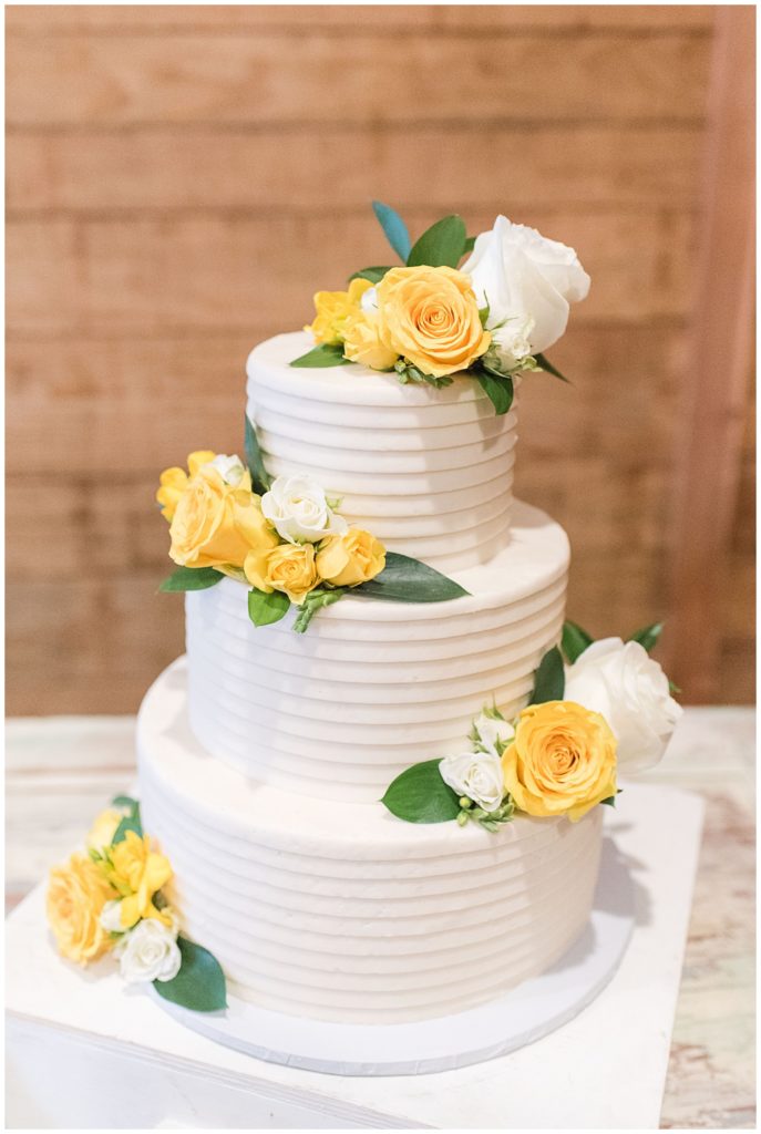 Yellow and white scrumptious cake at Emery's Buffalo Creek | Yellow Farmhouse style Wedding 