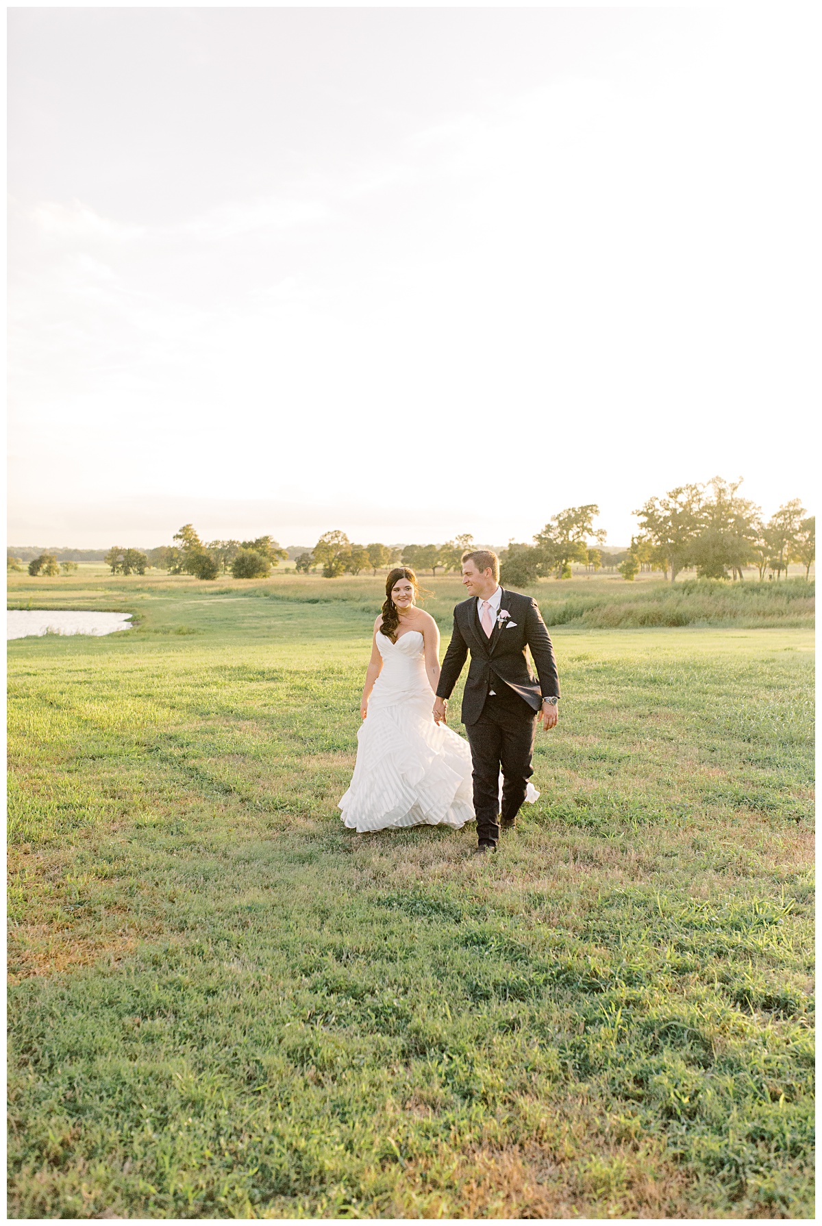Couple strolling at Emery's Buffalo Creek | Vintage Blush themed Wedding at Houston's only Winery Wedding Venue