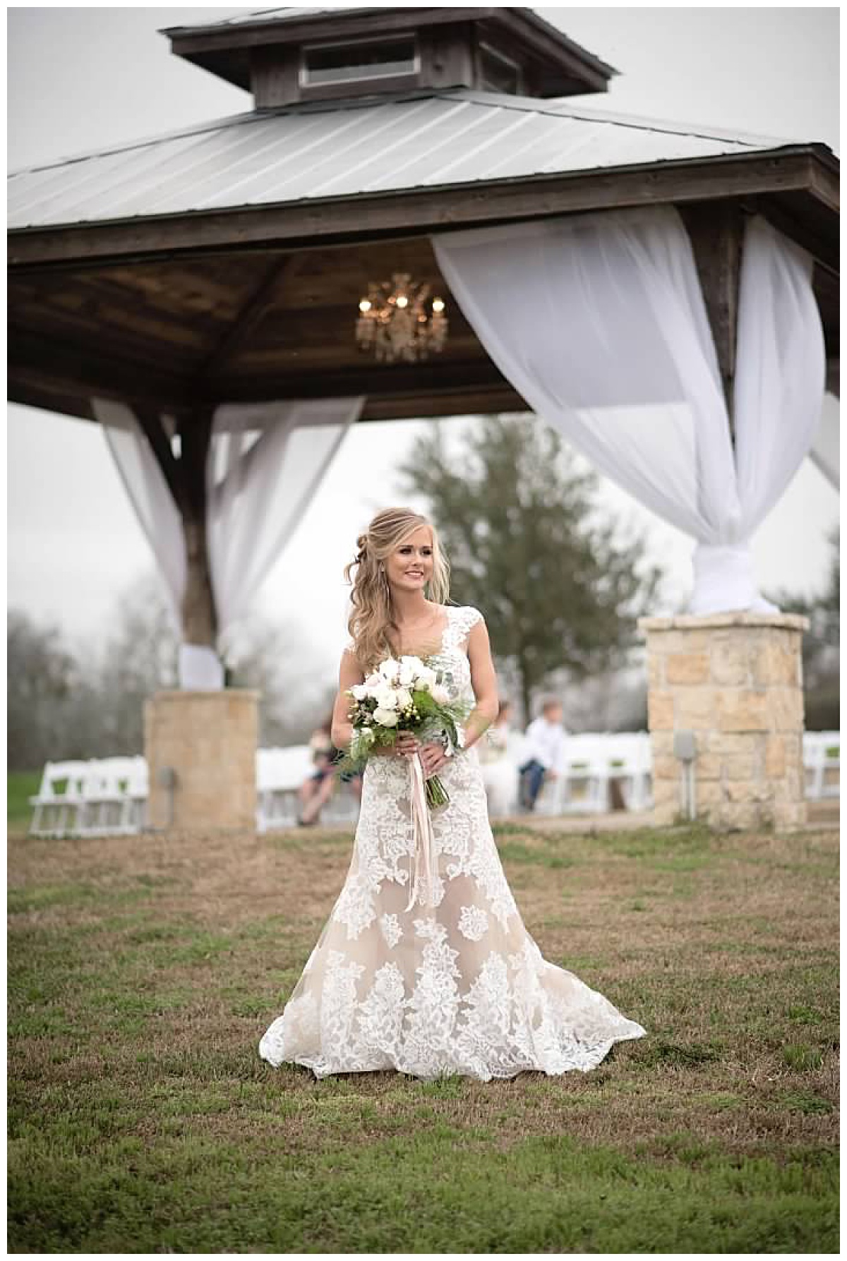 The Bride with her Bridal Bouquet behind her Ceremony space at Emery's Buffalo Creek