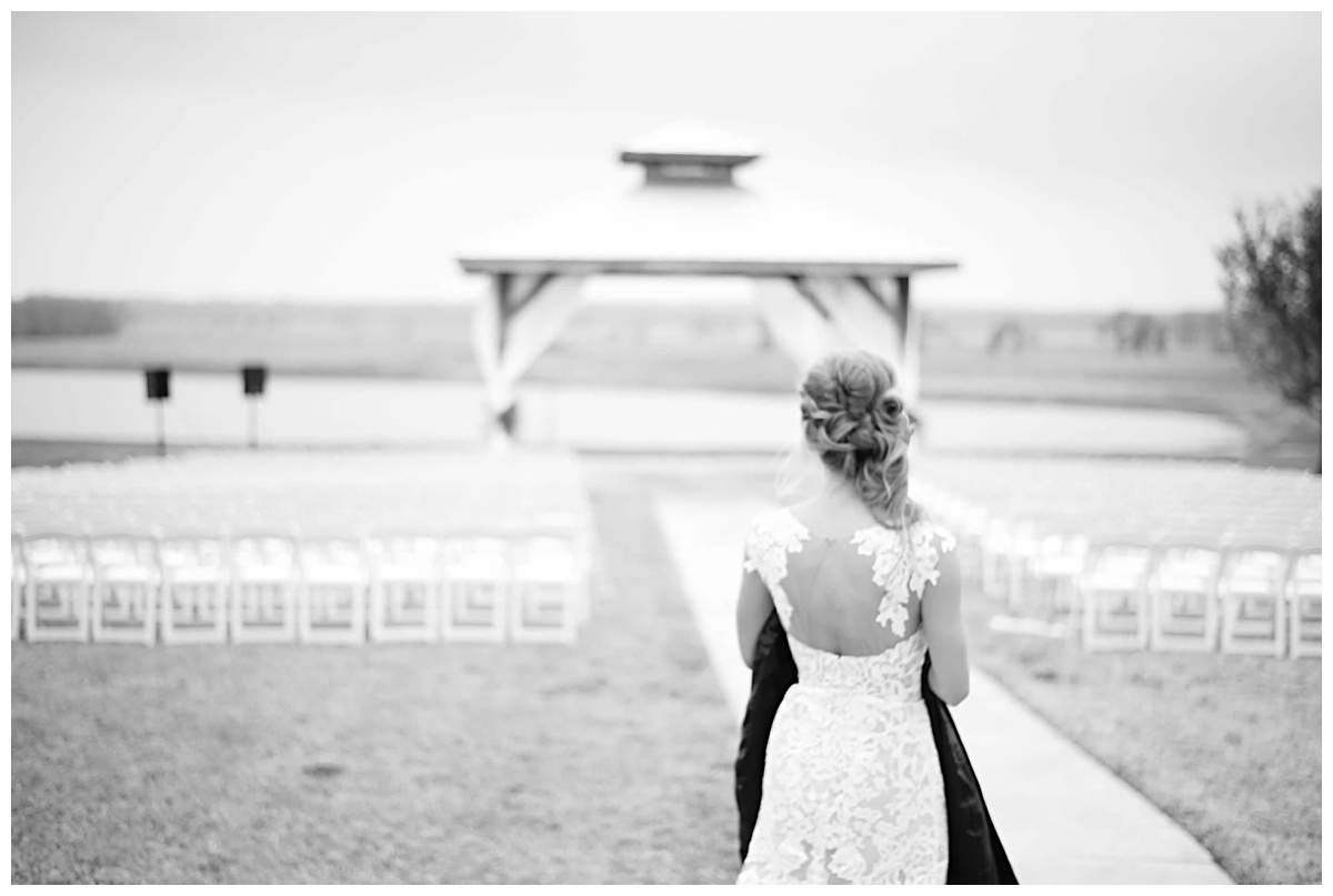 Bride with her Father's Harley Davidson jacket to place on an empty chair for his  presence at her Texas Winter Wedding 